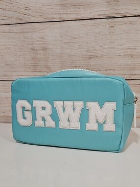 First Aid Beauty GRWM Cosmetic Bag in Aqua with White Applique